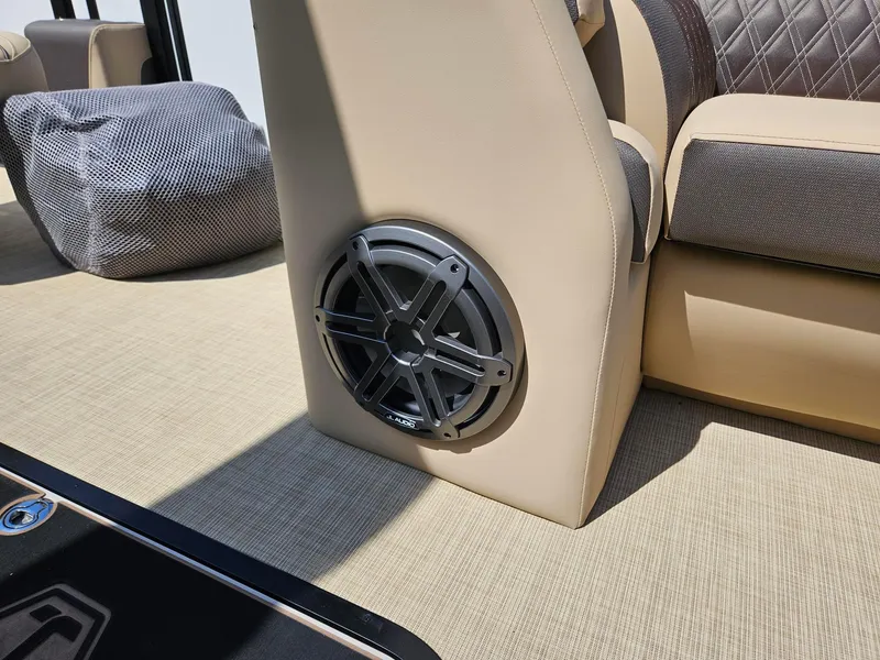 Slide: The Image of Speaker installed on 2025 Harris Sunliner 230 boat with beige and brown seating. - 14