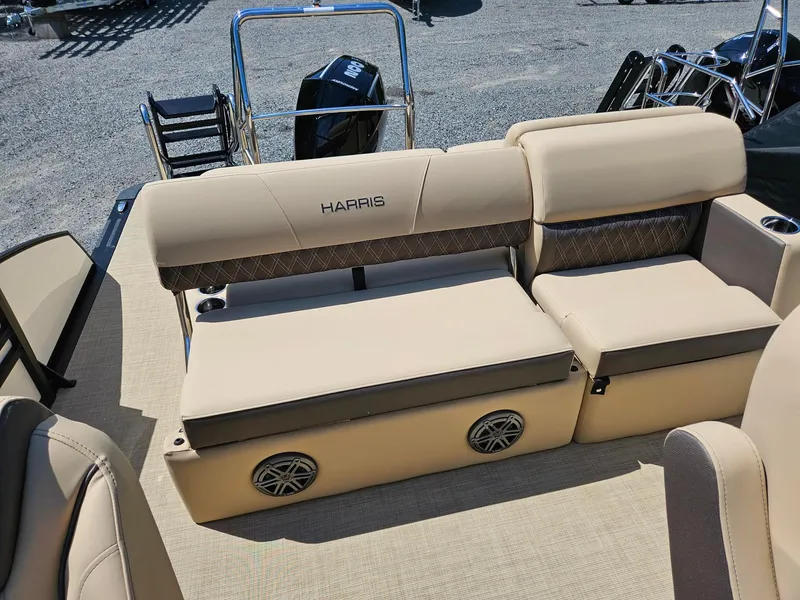 Slide: The Image of 2025 Harris Sunliner 230 boat interior with beige seating and integrated speakers. - 6