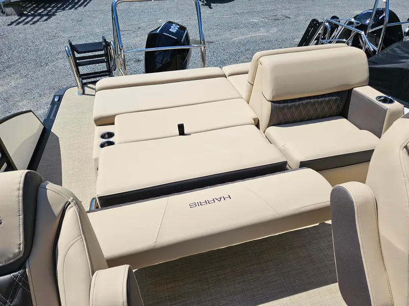 Slide: The Image of 2025 Harris Sunliner 230 boat interior with beige seating and cup holders. - 8