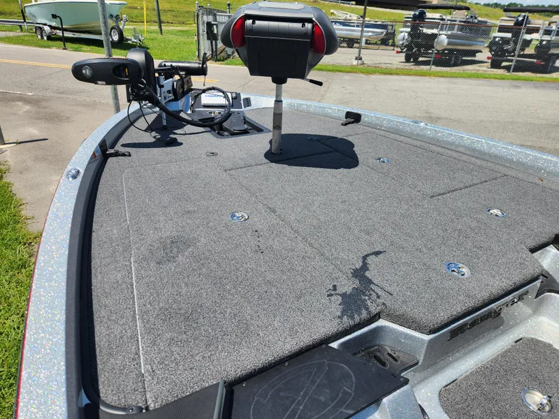 Slide: The Image of 2019 Ranger Z519L boat deck with trolling motor and seating, parked outdoors. - 11
