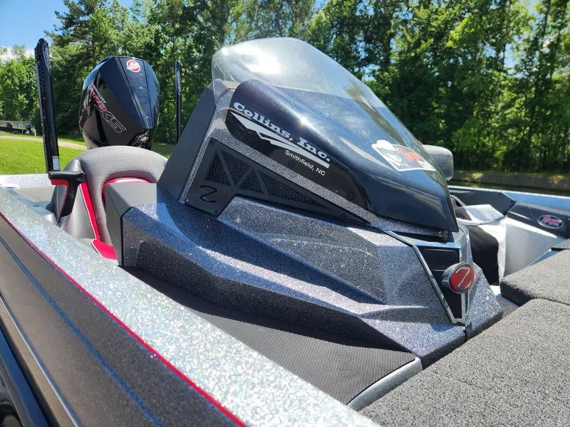 Slide: The Image of 2019 Ranger Z519L boat with sleek design and powerful engine, set against a lush green backdrop. - 13