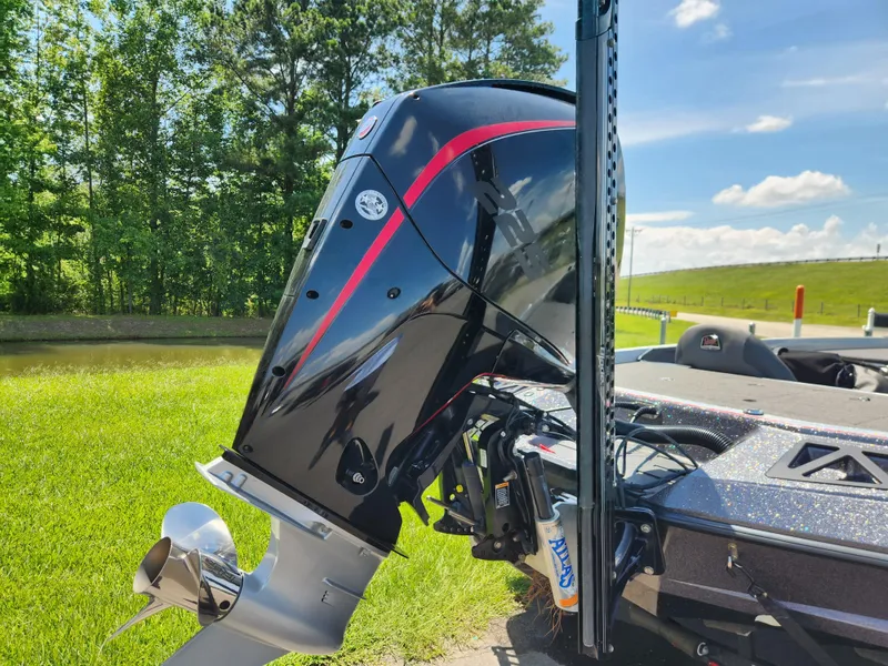 Slide: The Image of 2019 Ranger Z519L boat with a sleek black and red outboard motor, set against a lush green backdrop. - 3