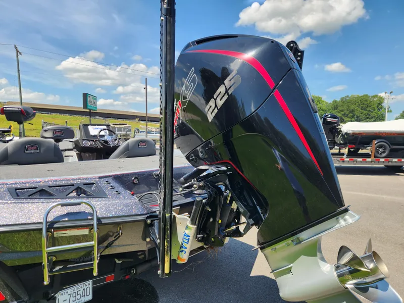 Slide: The Image of 2019 Ranger Z519L boat with powerful 225 engine, parked outdoors under a clear sky. - 4