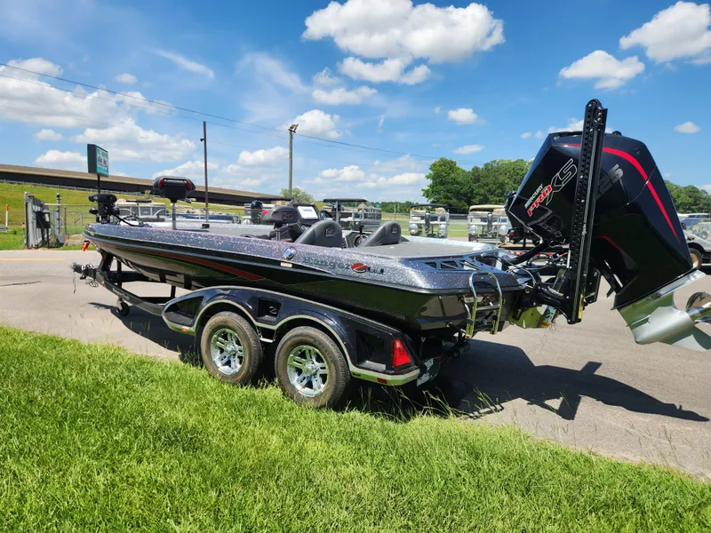 Slide: The Image of 2019 Ranger Z519L boat on trailer, parked on grass under blue sky. - 5