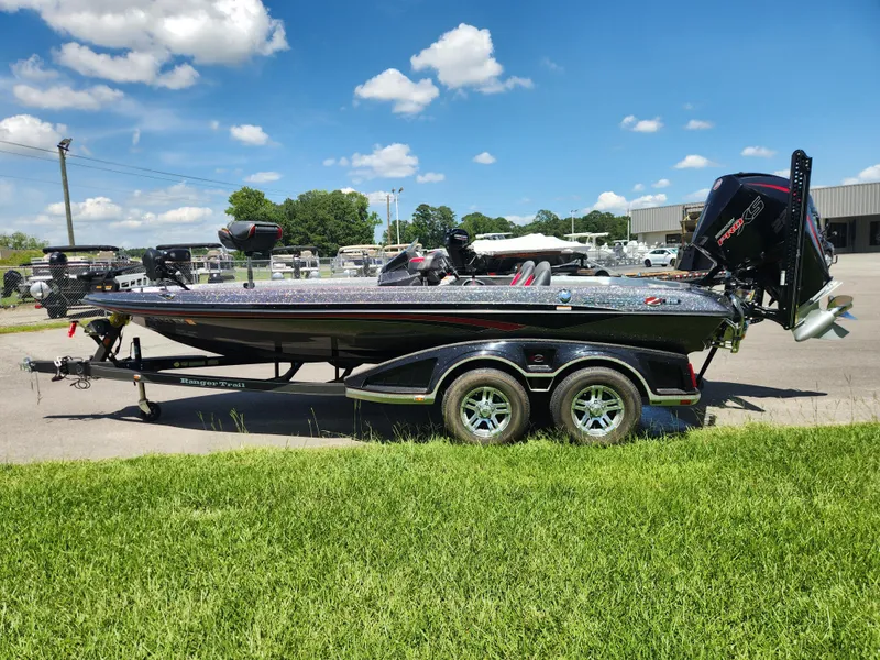 Slide: The Image of 2019 Ranger Z519L boat on trailer, parked outdoors under a clear blue sky. - 6