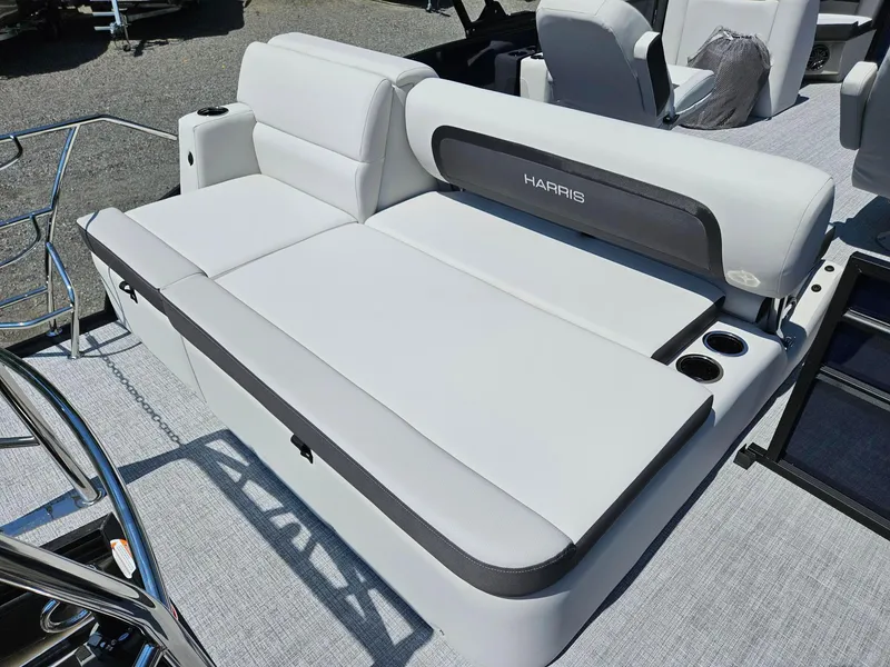 Slide: The Image of 2025 Harris Cruiser 210 boat interior with white seating and cup holders. - 14