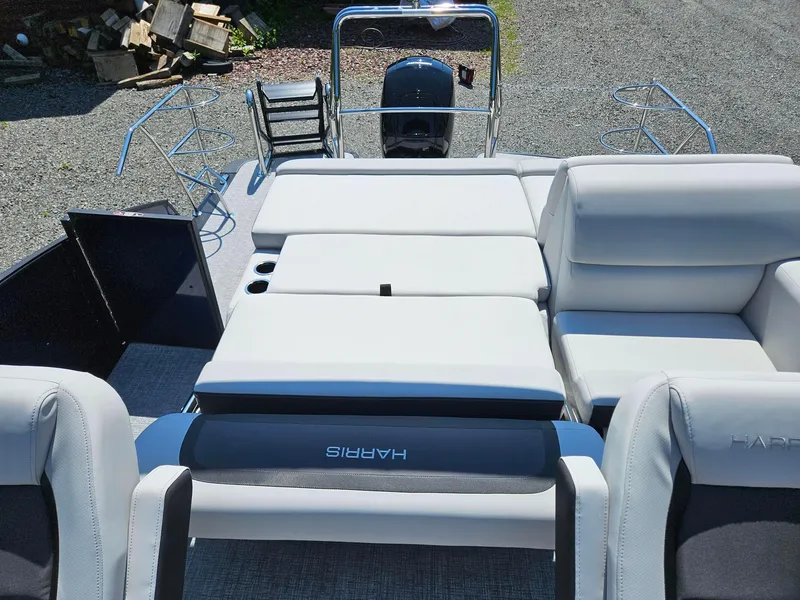 Slide: The Image of 2025 Harris Cruiser 210 boat interior with white seating and motor at the rear. - 15
