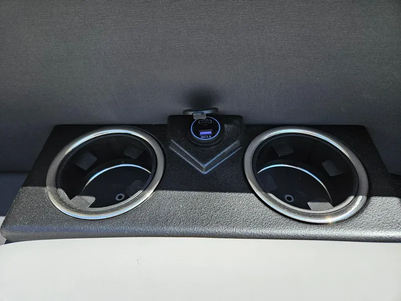 Slide: The Image of Cup holders and USB port in 2025 Harris Cruiser 210 boat interior. - 18