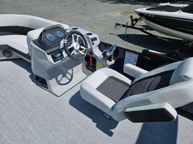 Slide: The Image of 2025 Harris Cruiser 210 boat interior with modern dashboard and comfortable seating. - 9