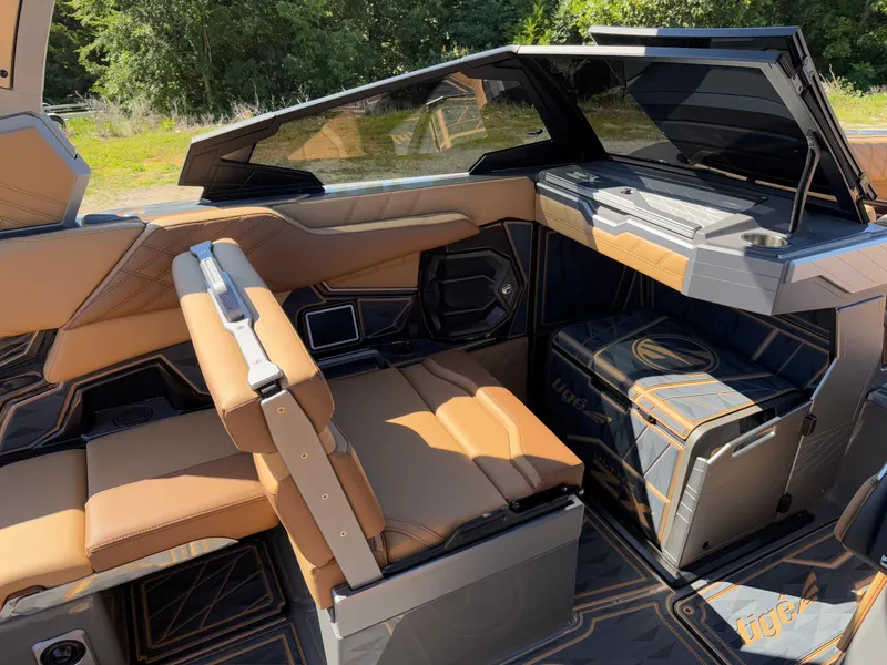 Slide: The Image of 2025 Tigé Ultré 25ZX boat interior with tan seating and modern design features. - 11