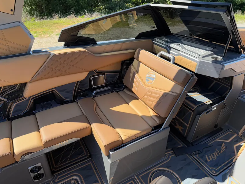 Slide: The Image of 2025 Tigé Ultré 25ZX boat interior with luxurious tan leather seating and modern design. - 12