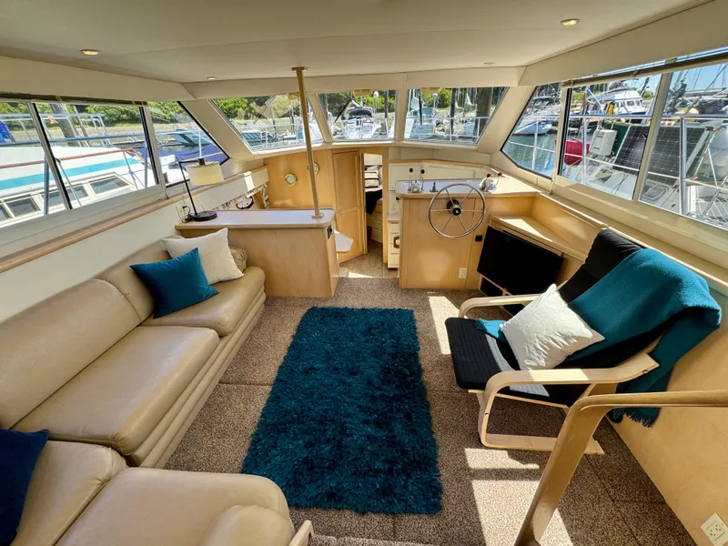 Slide: The Image of Luxurious 1997 Carver 405 Aft Cabin Motoryacht interior with plush seating and elegant decor. - 19
