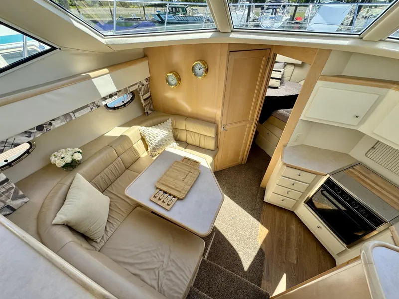 Slide: The Image of 1997 Carver 405 Aft Cabin Motoryacht interior with cozy seating and modern kitchen. - 24