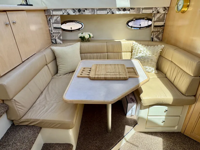 Slide: The Image of 1997 Carver 405 Aft Cabin Motoryacht interior with cozy seating and table. - 25