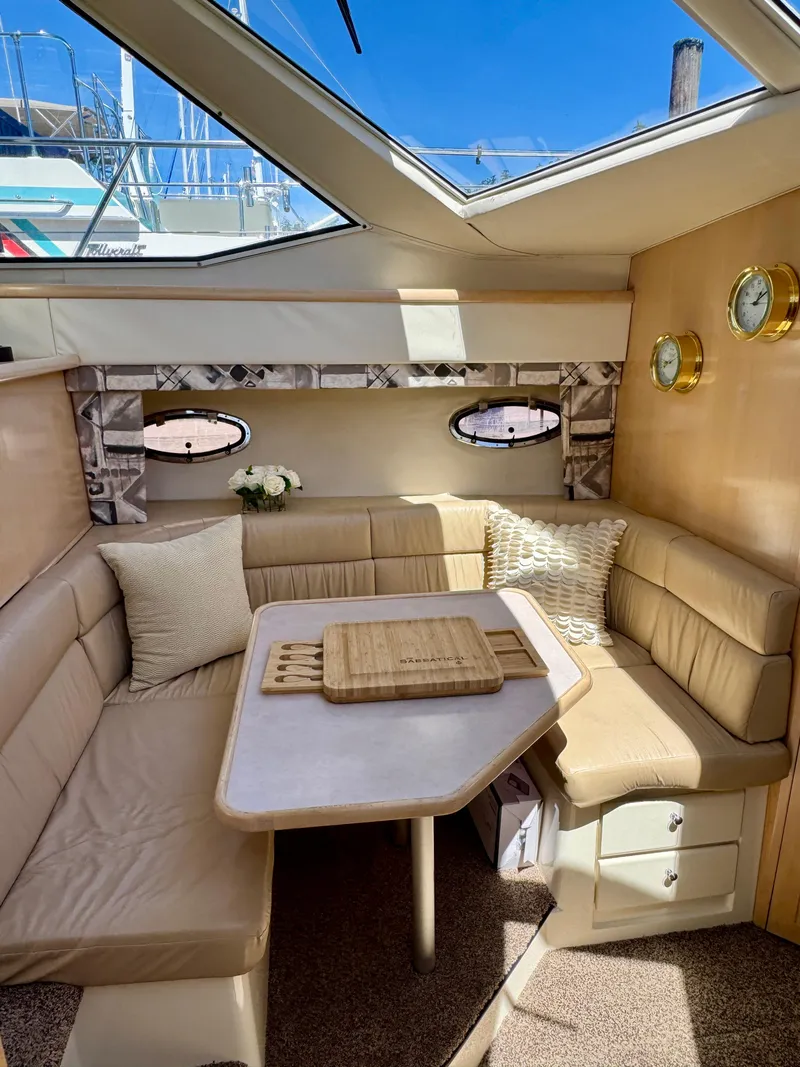 Slide: The Image of 1997 Carver 405 Aft Cabin Motoryacht interior with cozy seating and table under skylight. - 26