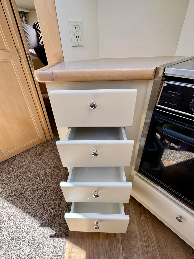 Slide: The Image of Open drawers in 1997 Carver 405 Aft Cabin Motoryacht kitchen area. - 29