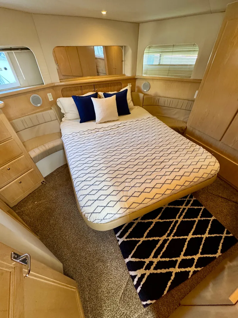 Slide: The Image of 1997 Carver 405 Aft Cabin Motoryacht bedroom with cozy bed and stylish decor. - 32
