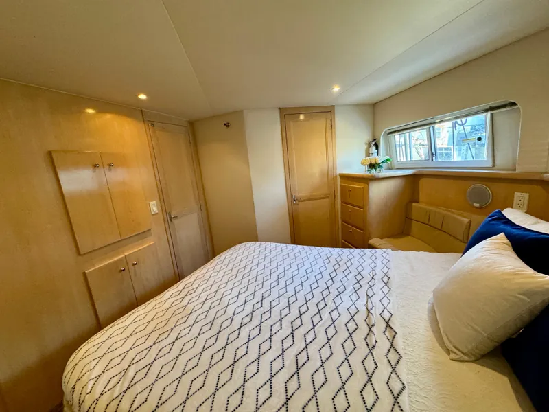 Slide: The Image of 1997 Carver 405 Aft Cabin Motoryacht bedroom with cozy bed and wooden cabinetry. - 34