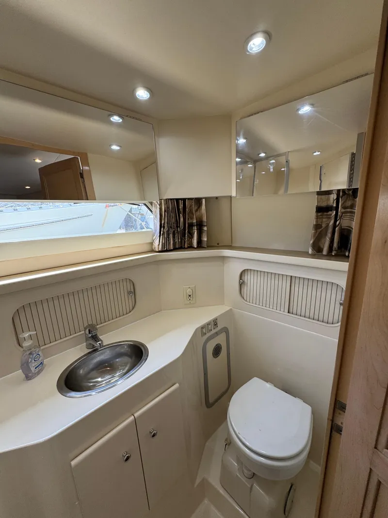 Slide: The Image of 1997 Carver 405 Aft Cabin Motoryacht bathroom with sink, toilet, and mirror. - 36