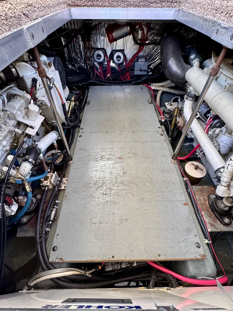 Slide: The Image of Engine room of a 1997 Carver 405 Aft Cabin Motoryacht, showcasing mechanical components. - 42