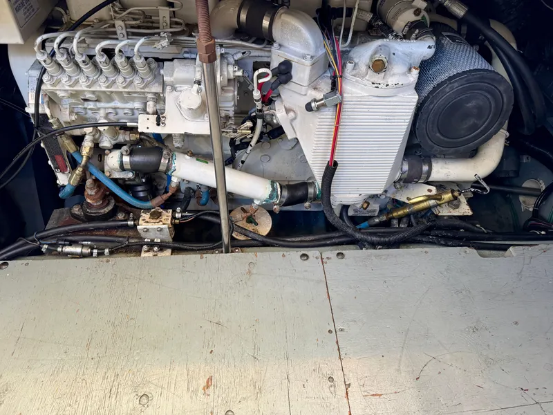 Slide: The Image of Engine compartment of a 1997 Carver 405 Aft Cabin Motoryacht, showcasing mechanical components. - 43