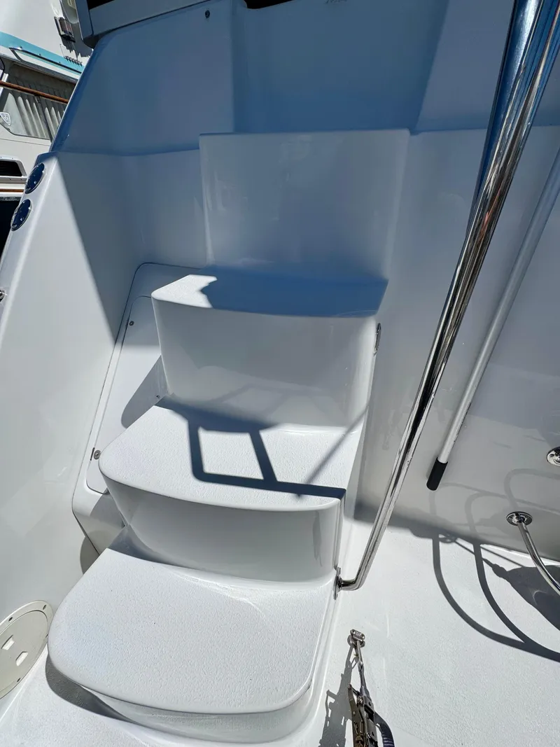 Slide: The Image of Staircase on 1997 Carver 405 Aft Cabin Motoryacht, featuring sleek white design and metal railing. - 5