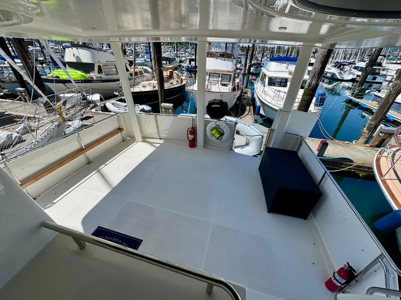 Slide: The Image of 1997 Carver 405 Aft Cabin Motoryacht deck view in marina setting. - 6