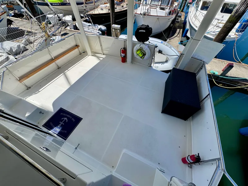 Slide: The Image of 1997 Carver 405 Aft Cabin Motoryacht deck with seating and safety equipment at marina. - 7