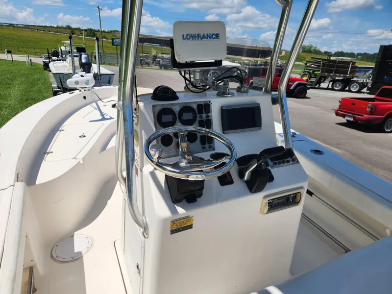 Slide: The Image of 2009 Pioneer 220 Bay Sport boat dashboard with steering wheel and navigation equipment. - 11