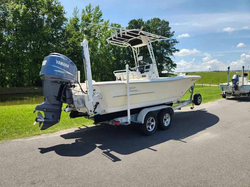 Slide: The Image of 2009 Pioneer 220 Bay Sport boat on trailer with Yamaha outboard motor. - 2