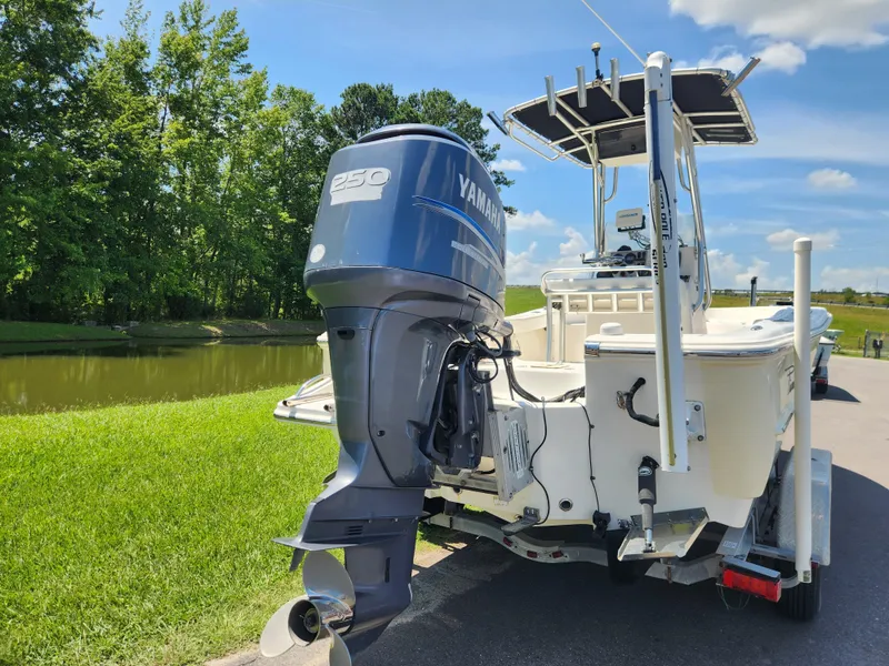 Slide: The Image of 2009 Pioneer 220 Bay Sport boat with Yamaha 250 engine by a lake. - 3