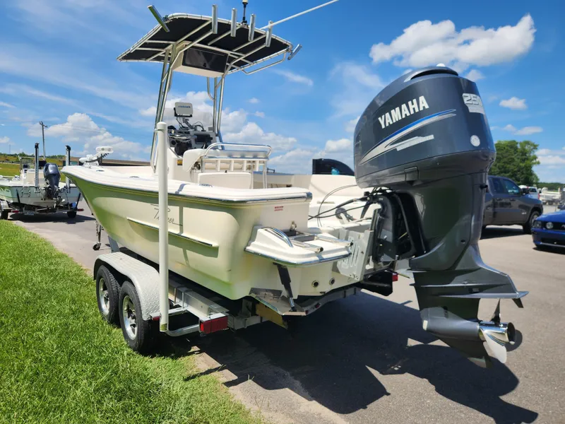 Slide: The Image of 2009 Pioneer 220 Bay Sport boat with Yamaha engine on trailer, parked outdoors. - 4