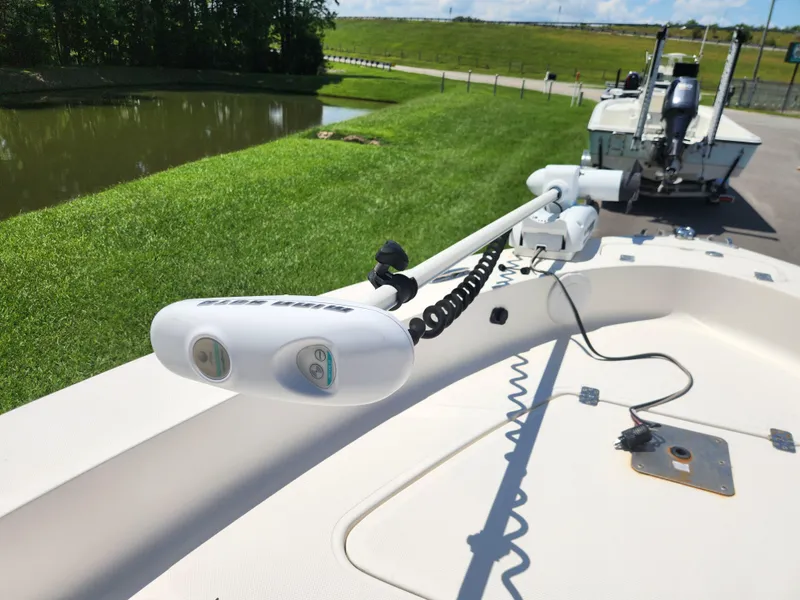 Slide: The Image of 2009 Pioneer 220 Bay Sport boat with trolling motor, parked near a pond. - 9