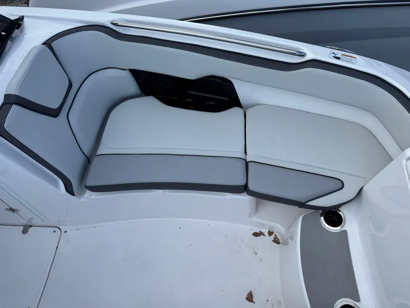 Slide: The Image of 2025 Yamaha AR250 boat interior seating with gray and white upholstery. - 10