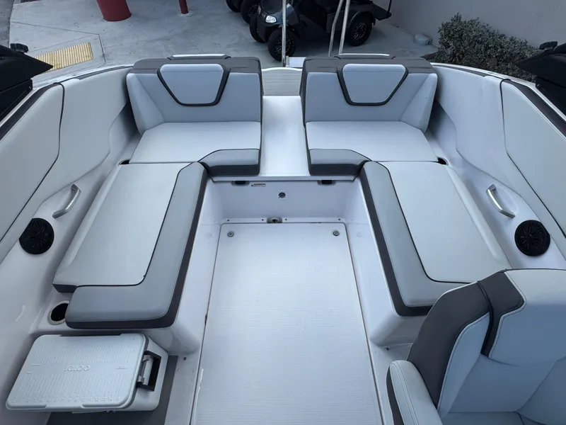 Slide: The Image of 2025 Yamaha Boats AR250 interior with gray seating and integrated speakers. - 15