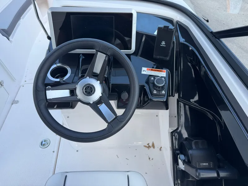Slide: The Image of 2025 Yamaha AR250 boat dashboard with steering wheel and control panel. - 18