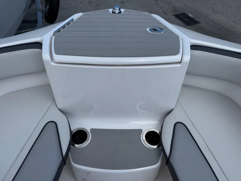Slide: The Image of 2025 Yamaha AR250 boat interior with cup holders and sleek seating design. - 6