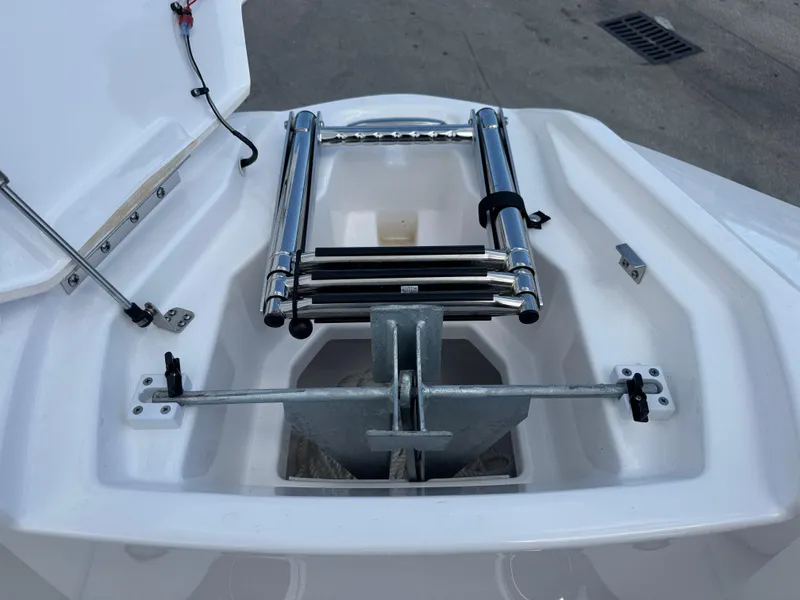 Slide: The Image of 2025 Yamaha Boats AR250 anchor compartment with ladder, open hatch view. - 7