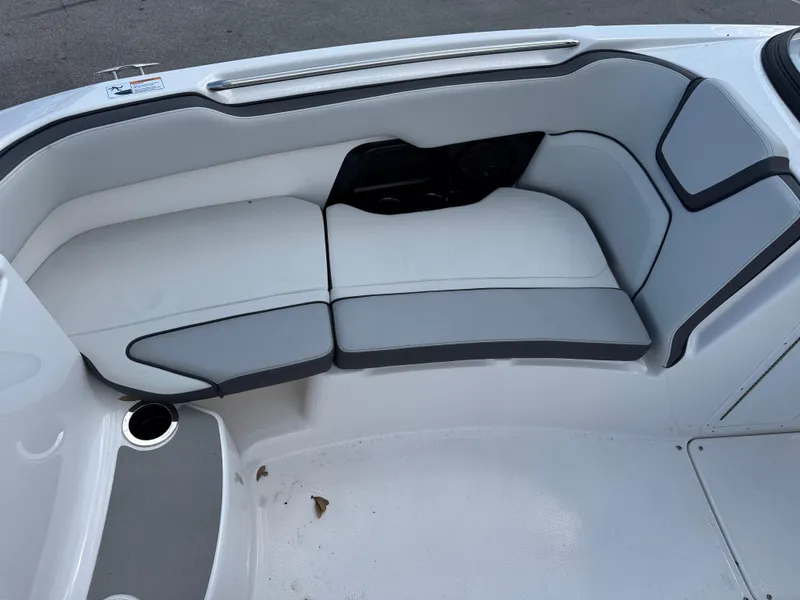 Slide: The Image of 2025 Yamaha Boats AR250 interior seating with gray and white upholstery. - 9
