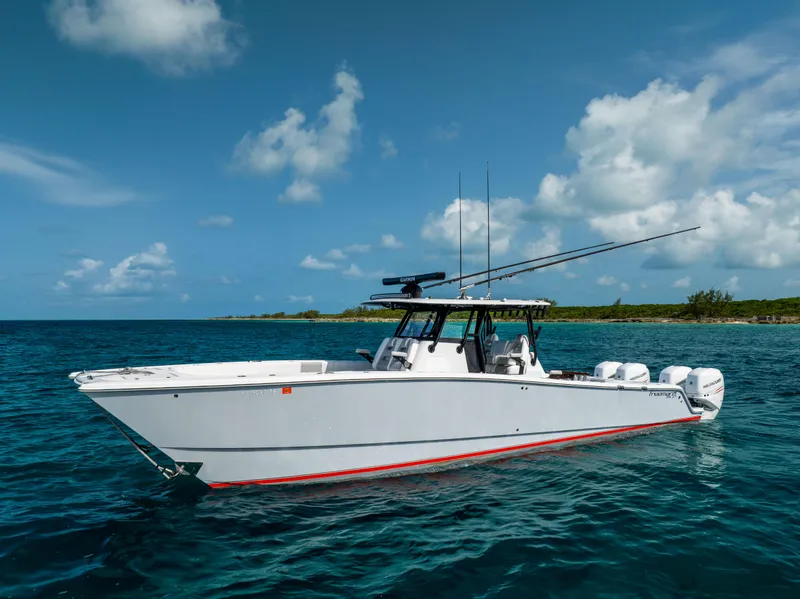 Slide: The Image of Freeman 37 VH 2022 boat on clear blue water under a partly cloudy sky. - 9