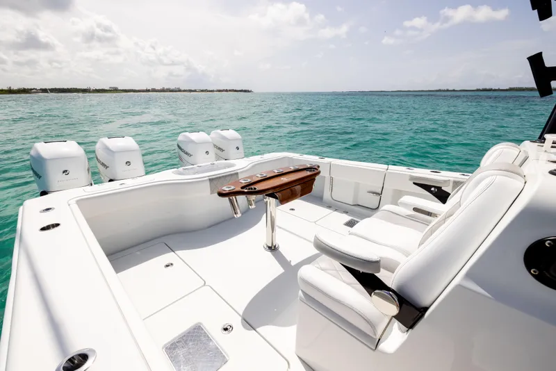 Slide: The Image of Luxury Freeman 37 VH boat interior with white seating, ocean view, and multiple engines, 2022 model. - 26