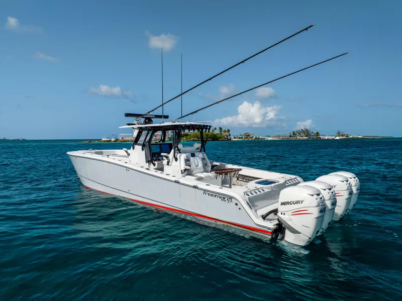 Slide: The Image of Freeman 37 VH 2022 boat with Mercury engines on blue ocean water. - 12