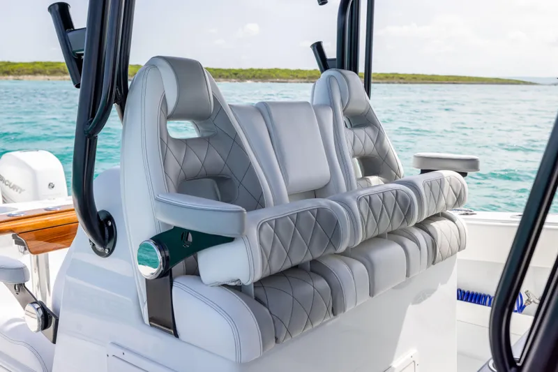 Slide: The Image of Luxury seating on a 2022 Freeman 37 VH boat, featuring quilted upholstery and ocean backdrop. - 36