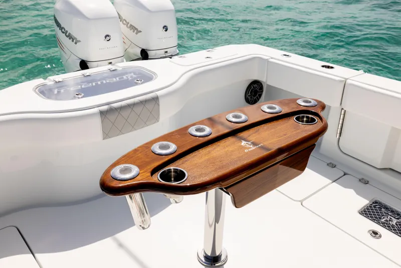 Slide: The Image of Freeman 37 VH 2022 boat with wooden rod holder, dual Mercury engines, on clear water. - 28