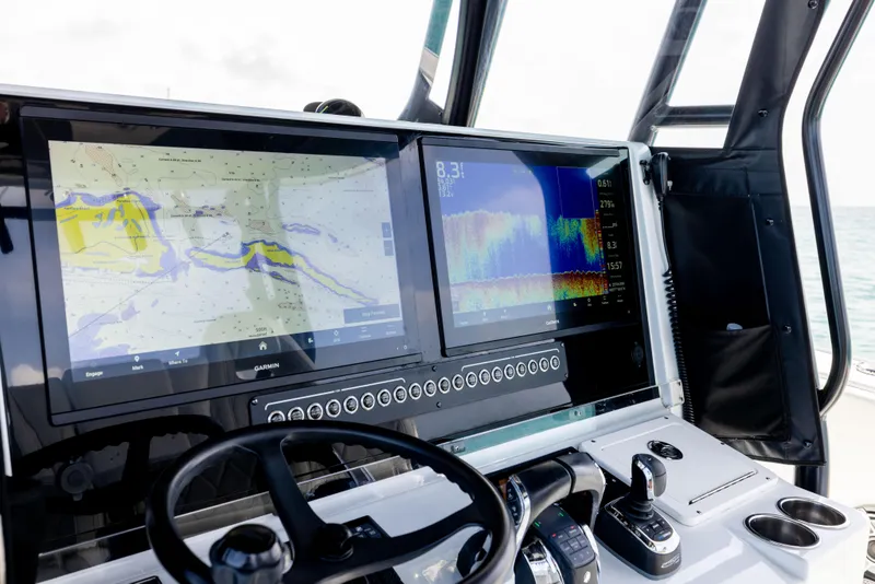Slide: The Image of Freeman 37 VH 2022 boat dashboard with dual Garmin navigation screens and controls. - 42