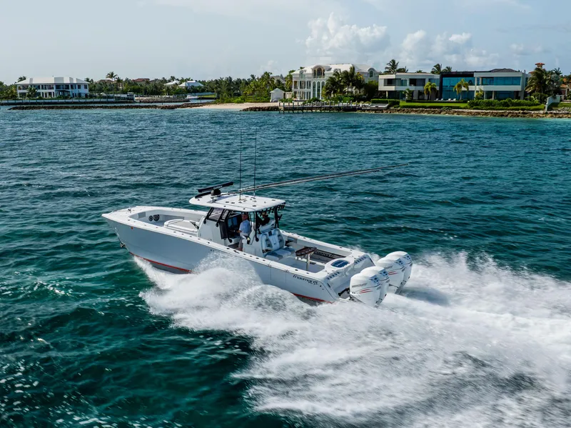 Slide: The Image of 2022 Freeman 37 VH boat cruising near luxury waterfront homes. - 1
