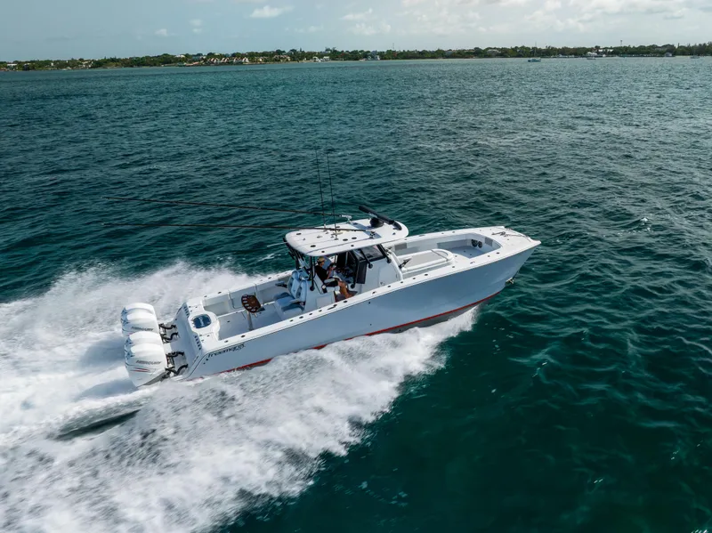 Slide: The Image of 2022 Freeman 37 VH boat speeding on open water, showcasing powerful engines and sleek design. - 4