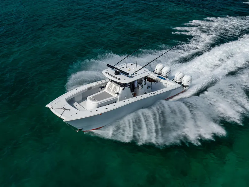 Slide: The Image of Freeman 37 VH 2022 boat cruising on clear turquoise water, aerial view. - 0
