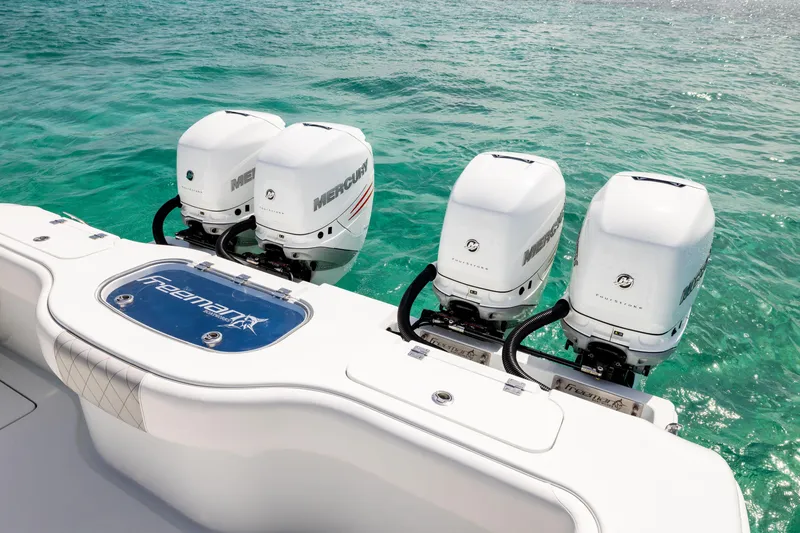 Slide: The Image of 2022 Freeman 37 VH boat with four Mercury outboard engines on turquoise water. - 23