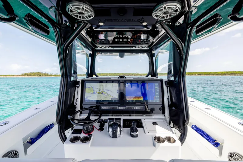 Slide: The Image of Freeman 37 VH 2022 boat cockpit with advanced navigation system on clear blue water. - 43